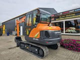 2024 Develon DX60E-10N mini excavator, rear three-quarter view