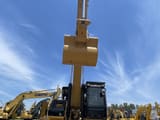 2023 Caterpillar 329D crawler excavator, front view with raised boom