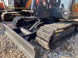 2023 Doosan DX60 mini excavator front view with blade