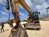2016 Caterpillar M320F wheel excavator, front-side view with bucket