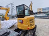 2023 Caterpillar 303.5E mini excavator, rear three-quarter view