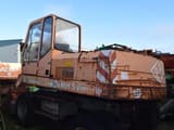 1990 O&K MH 5 wheel excavator, rear three-quarter view