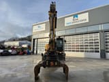 2016 Caterpillar MH3022 wheel excavator, front view with grapple attachment