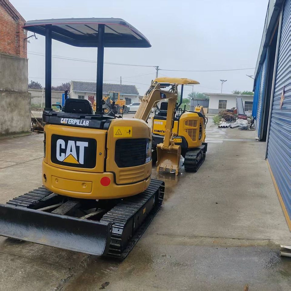 2022 Caterpillar 303E mini excavator, rear three-quarter view 2022 Caterpillar 303E mini excavator, rear three-quarter view