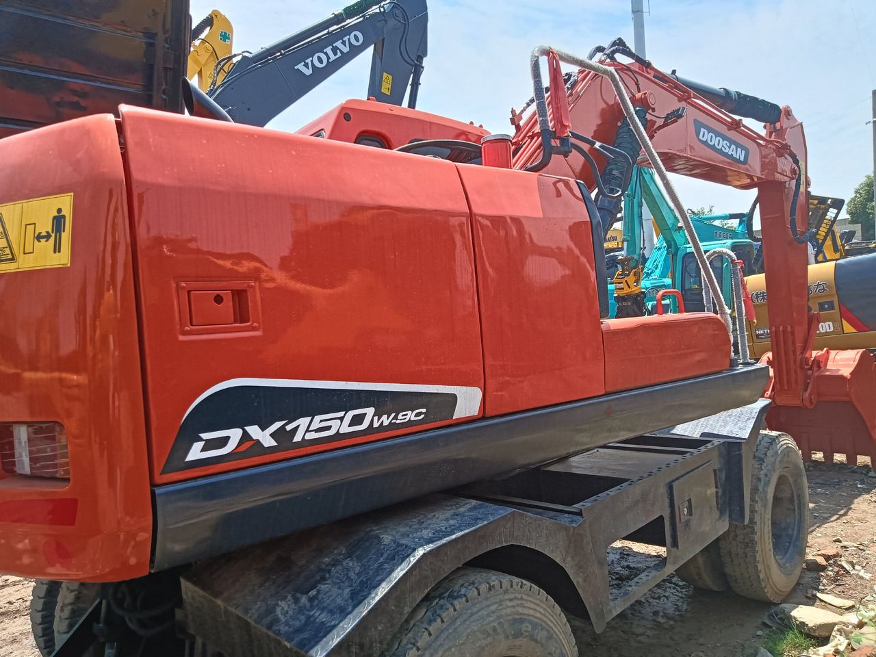 2021 Doosan DX150W-9C wheel excavator, rear three-quarter view 2021 Doosan DX150W-9C wheel excavator, rear three-quarter view