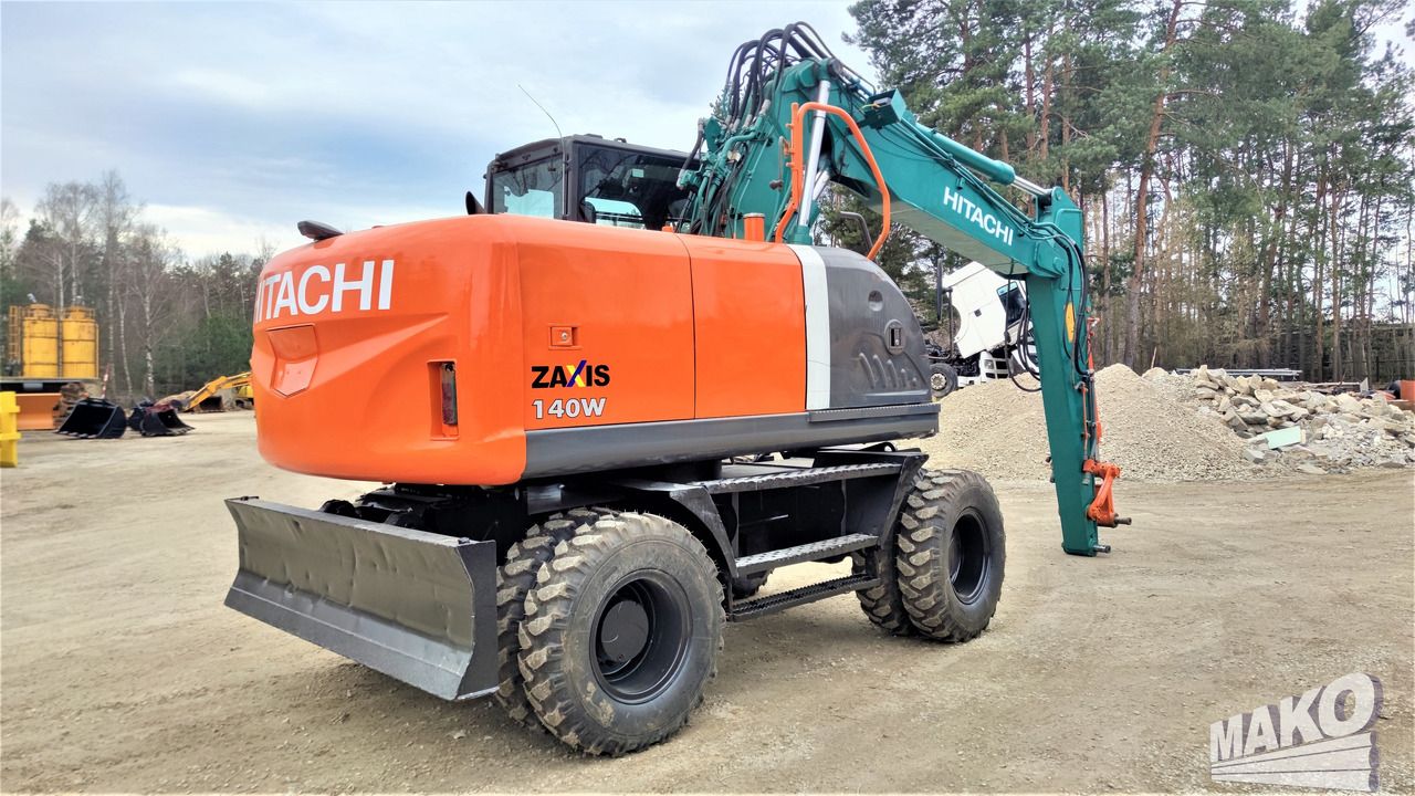 2012 Hitachi Zaxis 140W wheel excavator, rear three-quarter view 2012 Hitachi Zaxis 140W wheel excavator, rear three-quarter view