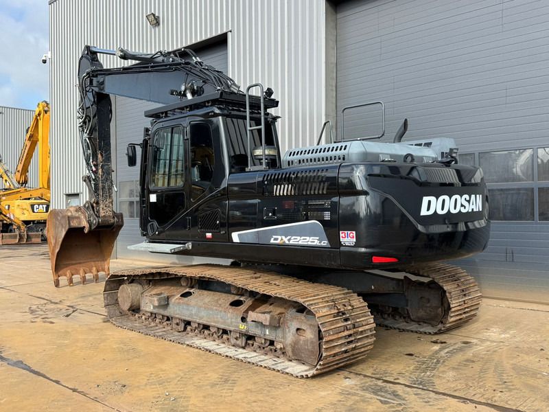 2021 Doosan DX225LC-5 crawler excavator, rear three-quarter view 2021 Doosan DX225LC-5 crawler excavator, rear three-quarter view