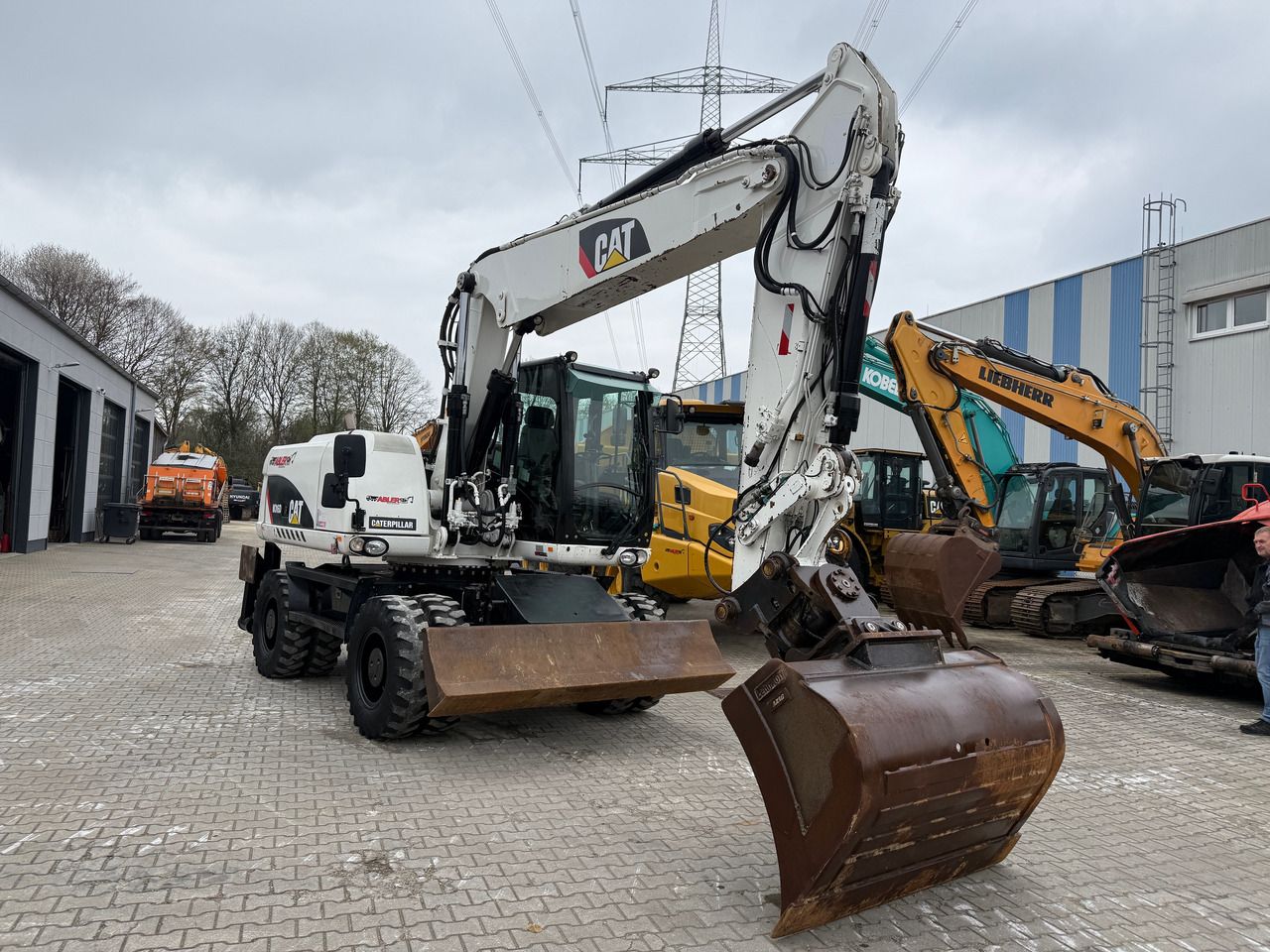 2010 Caterpillar M316D wheel excavator, front three-quarter view