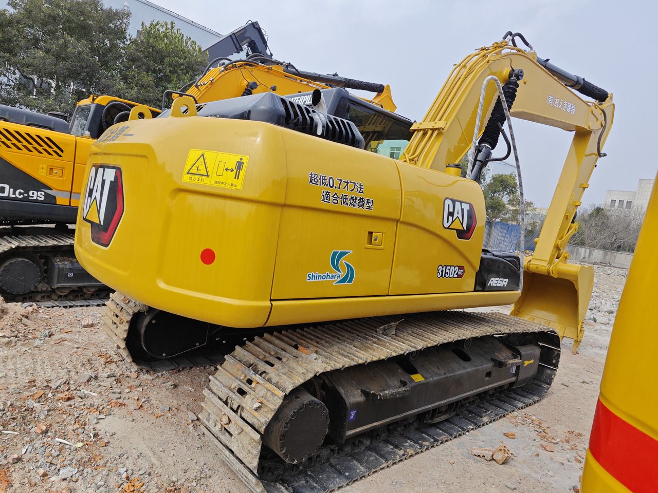 Caterpillar 315D2GC crawler excavator, rear three-quarter view Caterpillar 315D2GC crawler excavator, rear three-quarter view