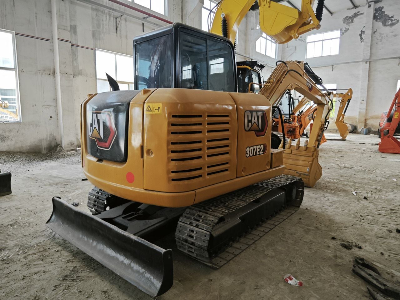 Caterpillar 307E2 mini excavator, rear three-quarter view