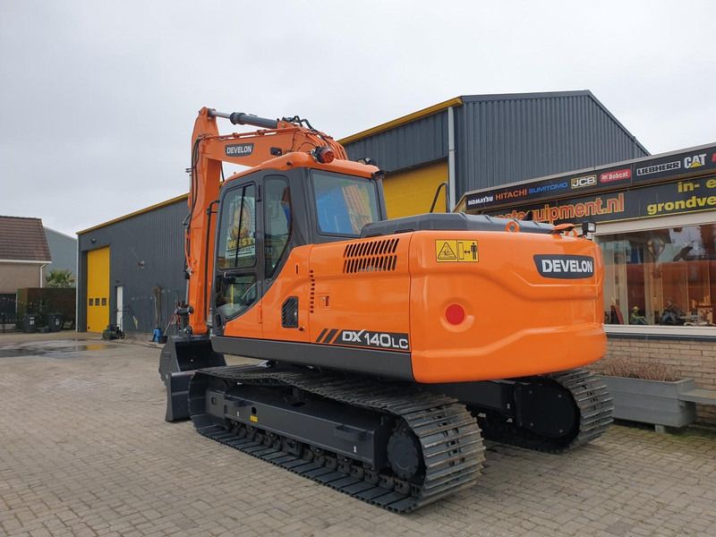 2023 Develon DX140LC crawler excavator, rear three-quarter view