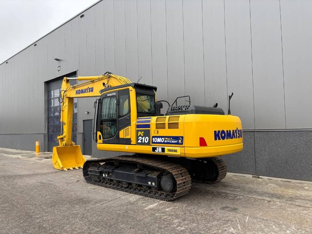 2024 Komatsu PC210-10M0 crawler excavator, rear three-quarter view 2024 Komatsu PC210-10M0 crawler excavator, rear three-quarter view