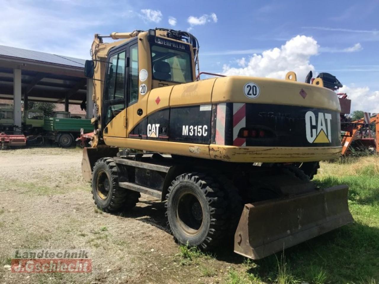 2003 Caterpillar M315C wheel excavator, rear three-quarter view 2003 Caterpillar M315C wheel excavator, rear three-quarter view
