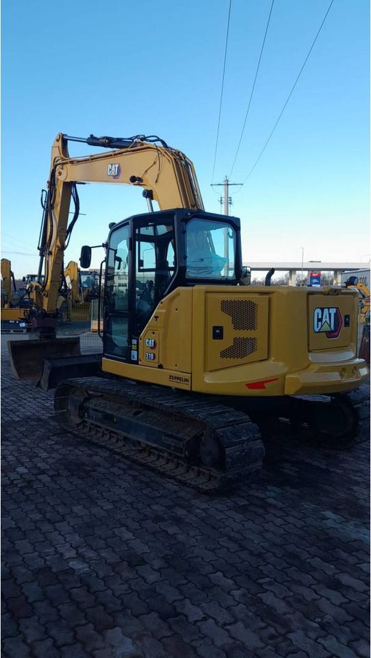 2021 Caterpillar 310-07 crawler excavator, rear three-quarter view 2021 Caterpillar 310-07 crawler excavator, rear three-quarter view