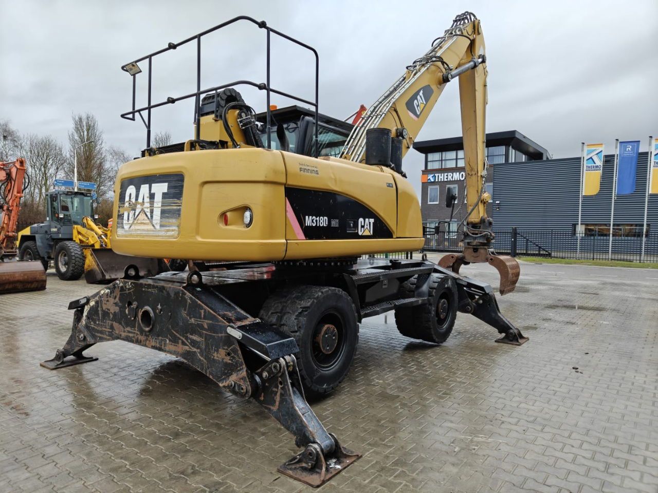 2010 Caterpillar M318D MH demolition excavator rear three-quarter view 2010 Caterpillar M318D MH demolition excavator rear three-quarter view