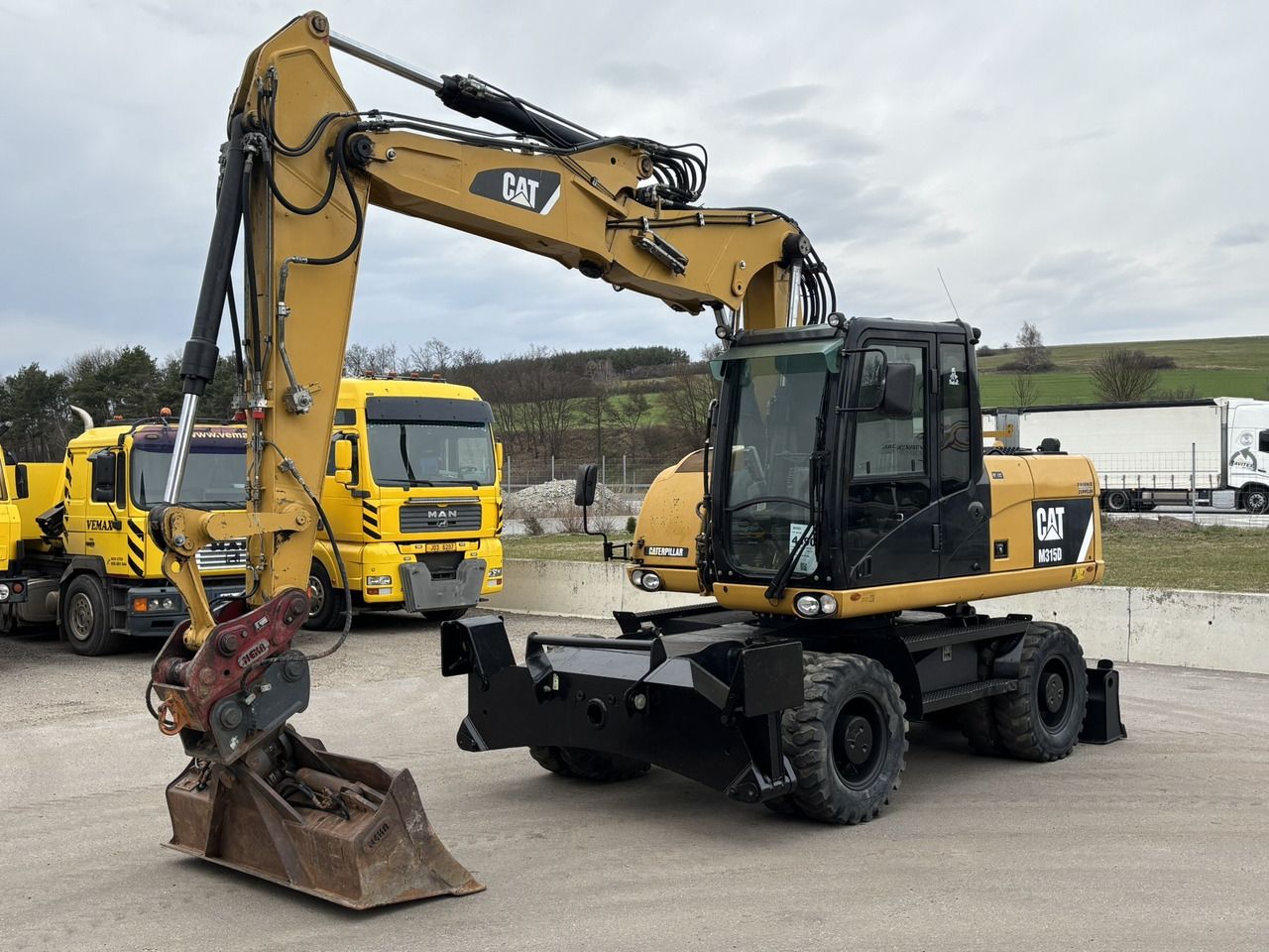 2012 Caterpillar M315D wheel excavator, front three-quarter view 2012 Caterpillar M315D wheel excavator, front three-quarter view