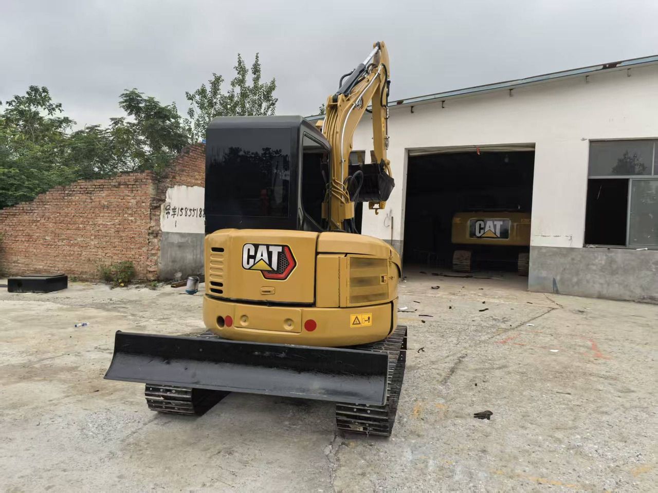 2023 Caterpillar 303.5E mini excavator, rear view