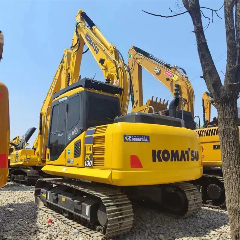 Komatsu PC130 crawler excavator, rear three-quarter view Komatsu PC130 crawler excavator, rear three-quarter view