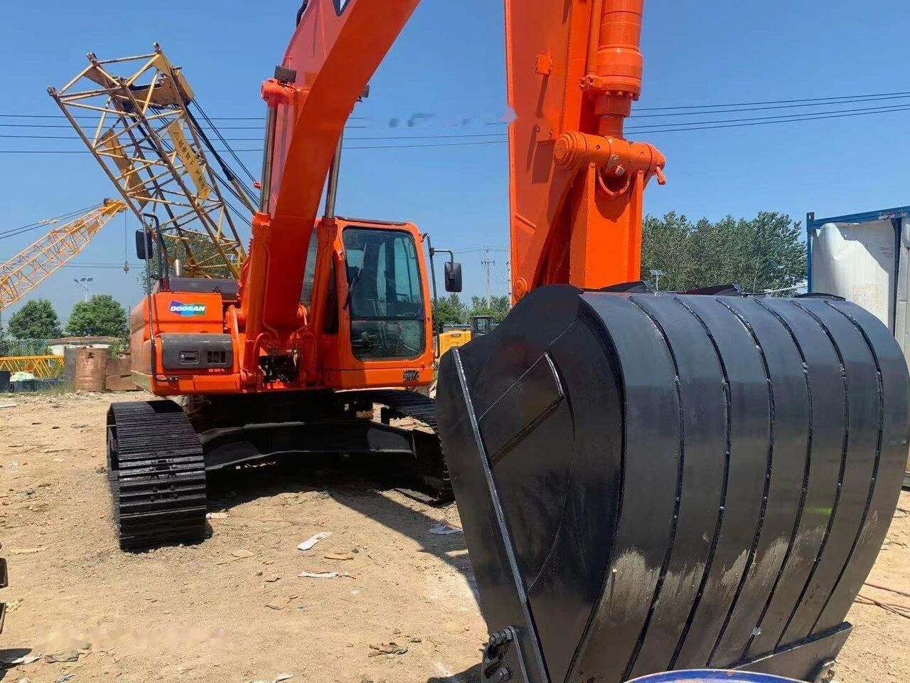 Doosan DX300 crawler excavator front view with bucket Doosan DX300 crawler excavator front view with bucket