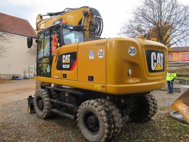 2021 Caterpillar M320F wheel excavator rear three-quarter view 2021 Caterpillar M320F wheel excavator rear three-quarter view