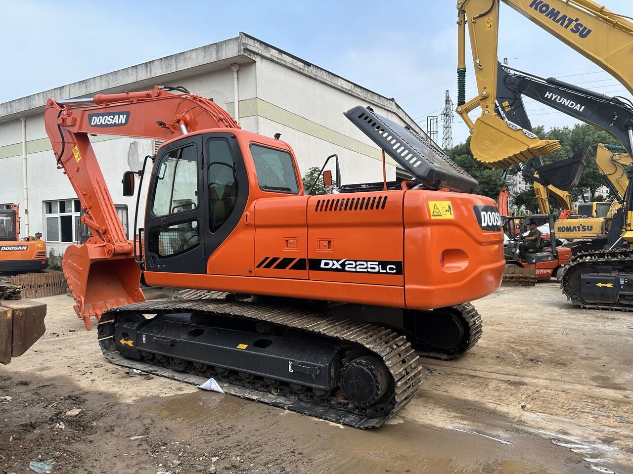 2023 Doosan DX225LC crawler excavator, rear three-quarter view 2023 Doosan DX225LC crawler excavator, rear three-quarter view