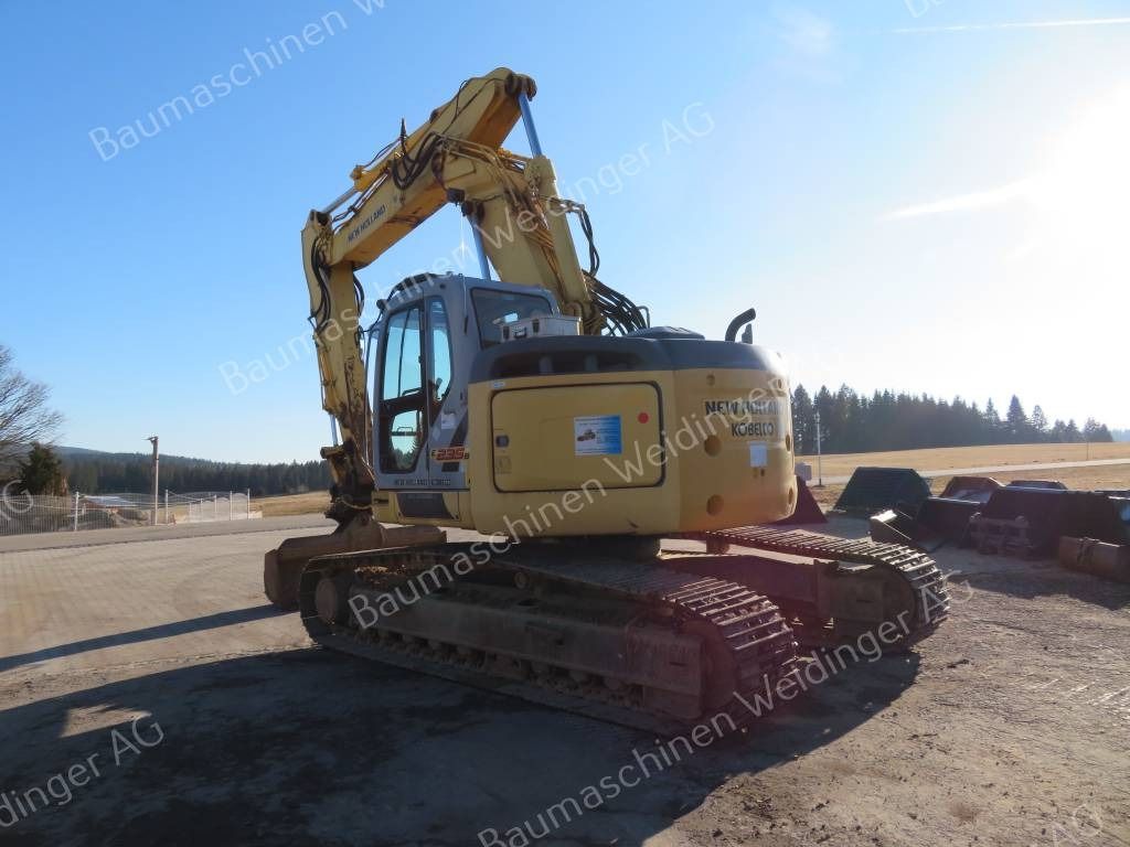 2009 New Holland E235BSR-2 ES crawler excavator, rear three-quarter view 2009 New Holland E235BSR-2 ES crawler excavator, rear three-quarter view
