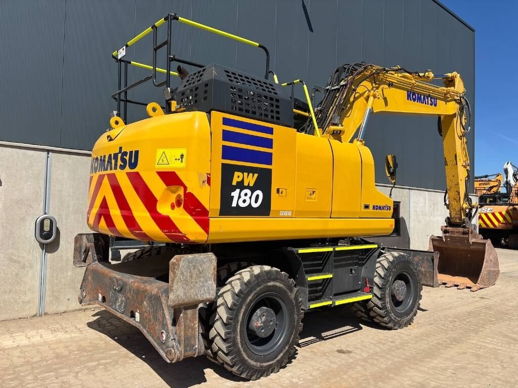 2022 Komatsu PW180 wheel excavator, rear three-quarter view 2022 Komatsu PW180 wheel excavator, rear three-quarter view