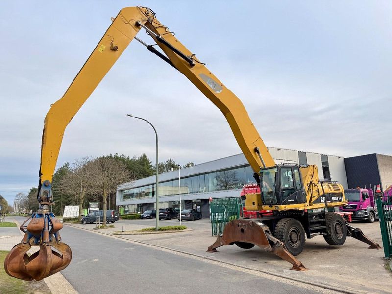 2011 Caterpillar 325D material handler, side view with grapple
