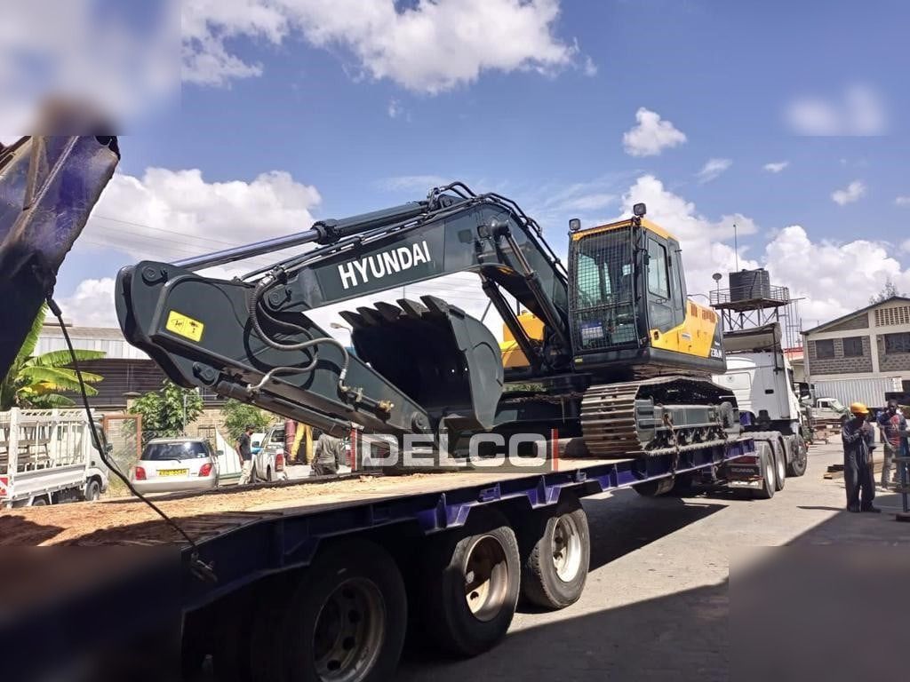 2026 Hyundai R210 crawler excavator on a flatbed trailer, side view 2026 Hyundai R210 crawler excavator on a flatbed trailer, side view