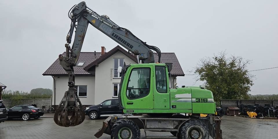 2011 Liebherr A316 LITRONIC wheel excavator side view