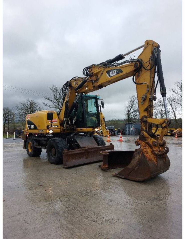 2012 Caterpillar M313D wheel excavator, front three-quarter view