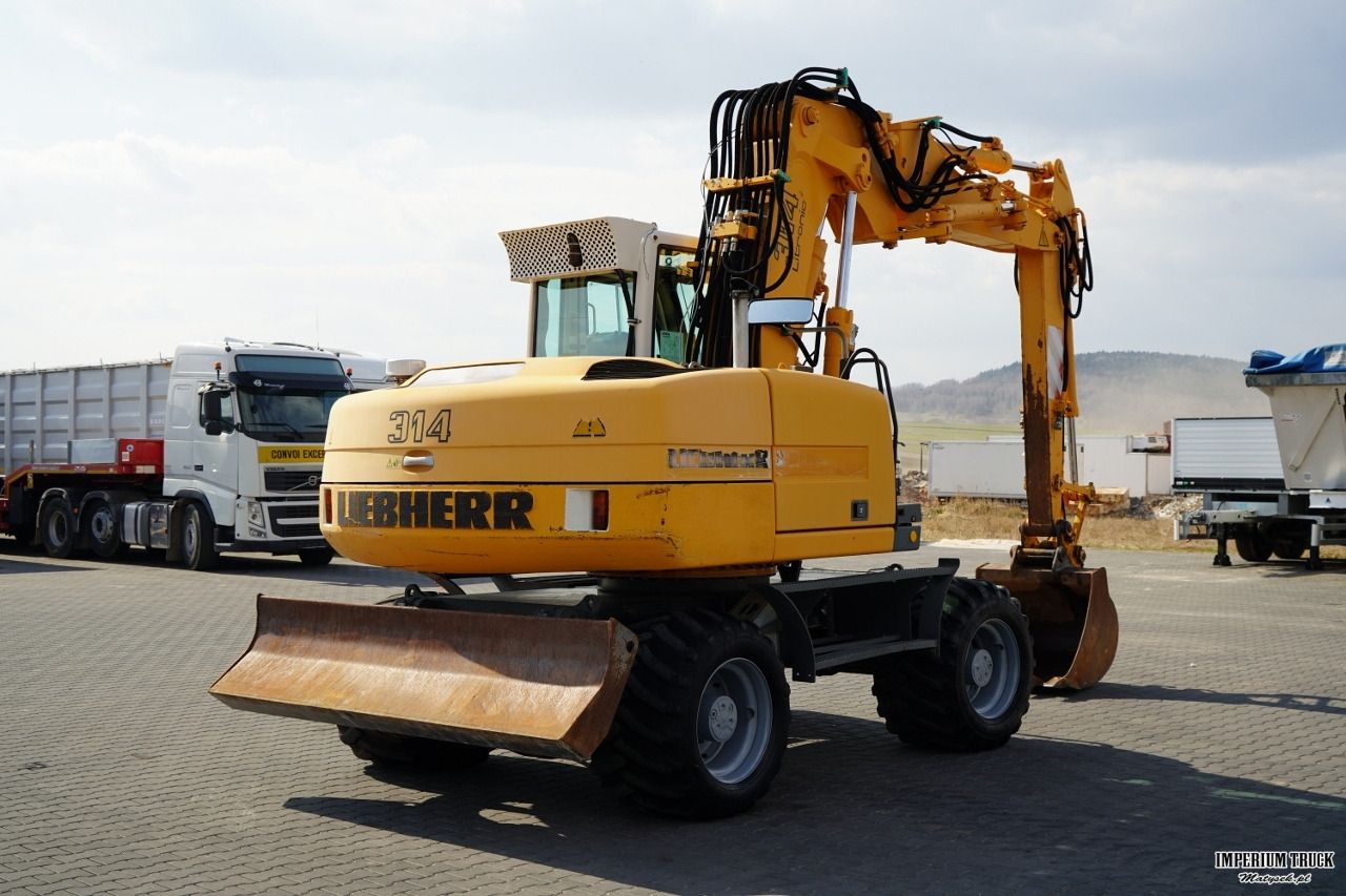 2001 Liebherr A314 LITRONIC wheel excavator rear three-quarter view 2001 Liebherr A314 LITRONIC wheel excavator rear three-quarter view