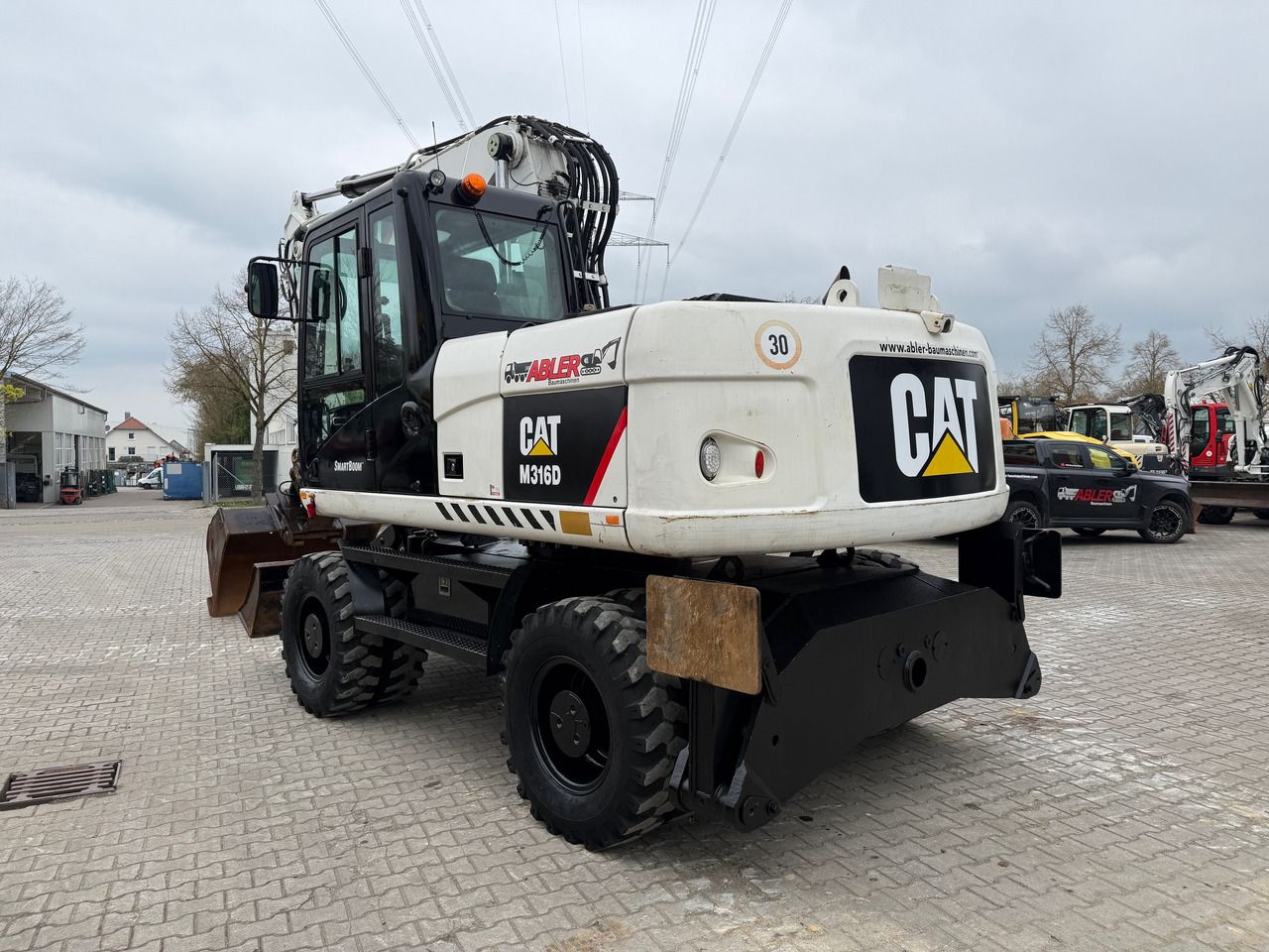 2010 Caterpillar M316D wheel excavator, rear three-quarter view