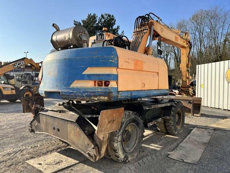 1997 Caterpillar M315 wheel excavator, rear three-quarter view 1997 Caterpillar M315 wheel excavator, rear three-quarter view