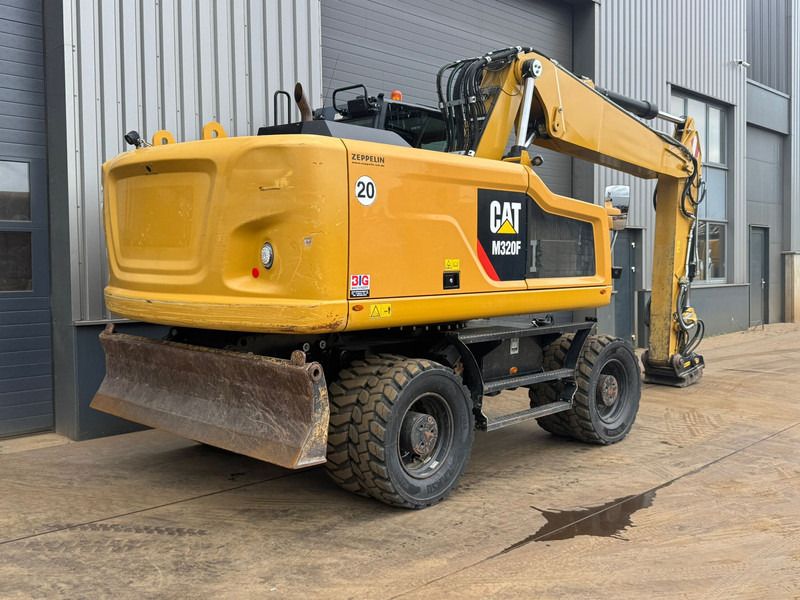2017 Caterpillar M320F wheel excavator, rear three-quarter view 2017 Caterpillar M320F wheel excavator, rear three-quarter view