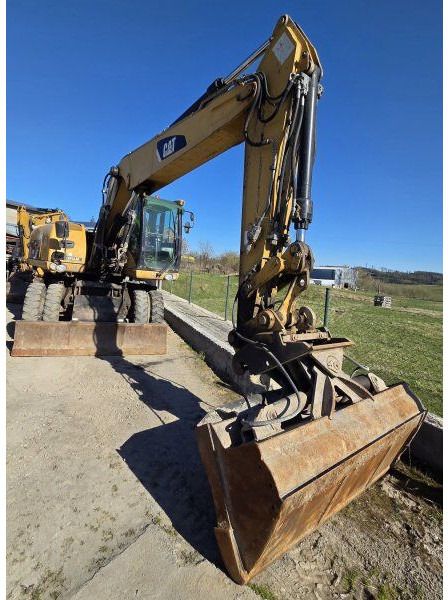 2009 Caterpillar M318D wheel excavator, front three-quarter view