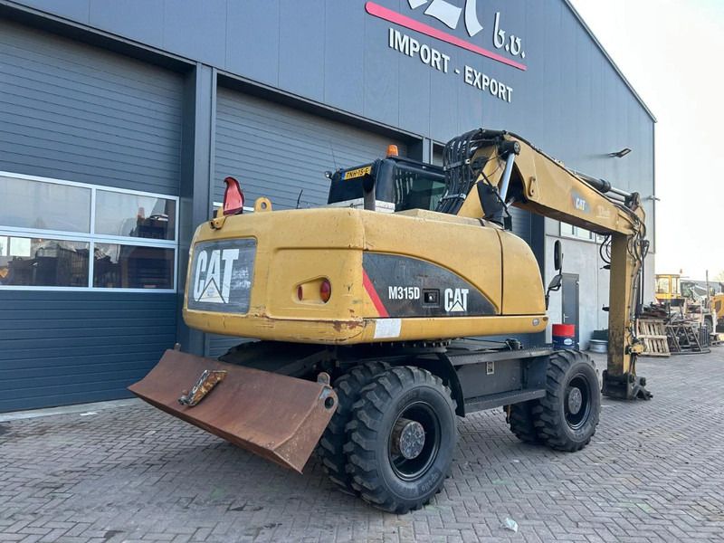 2011 Caterpillar M315D wheel excavator, rear three-quarter view