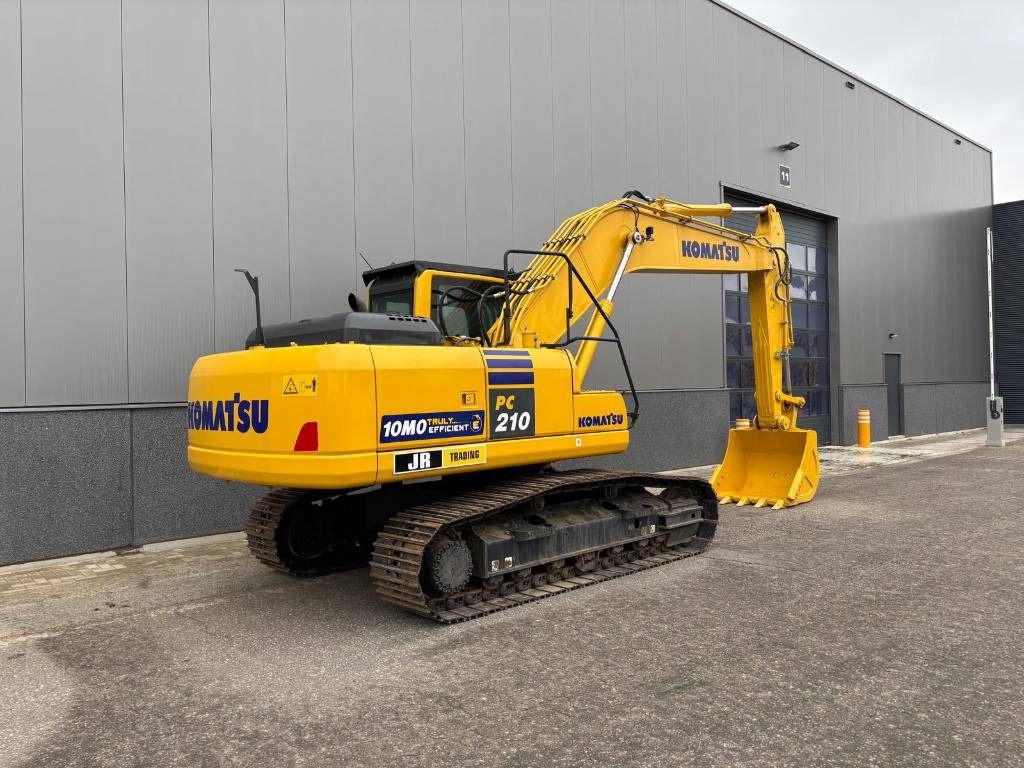 2024 Komatsu PC210-10M0 crawler excavator, rear three-quarter view 2024 Komatsu PC210-10M0 crawler excavator, rear three-quarter view