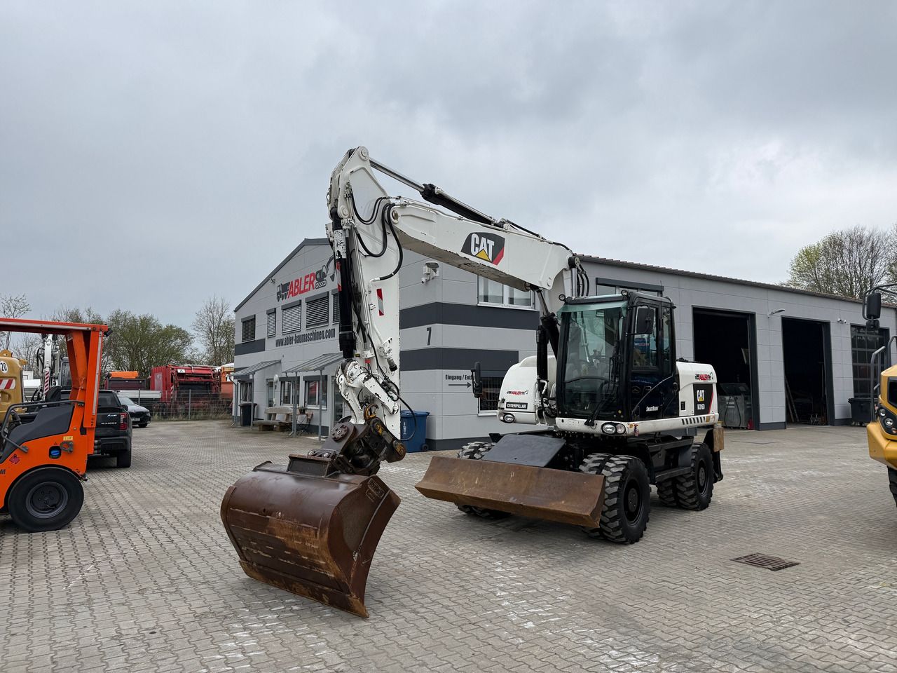 2010 Caterpillar M316D wheel excavator, front three-quarter view