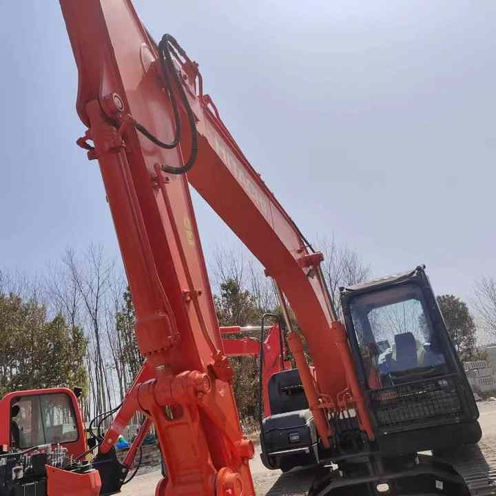 Hitachi ZX120 crawler excavator, low angle view of boom and cab Hitachi ZX120 crawler excavator, low angle view of boom and cab