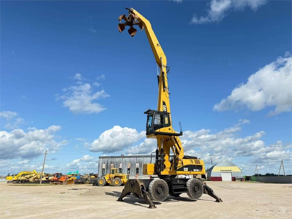 2010 Caterpillar M325D MH wheel excavator, side view