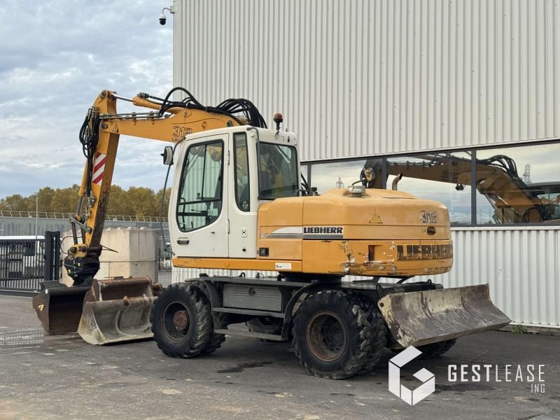 2004 Liebherr A312 wheel excavator, rear three-quarter view 2004 Liebherr A312 wheel excavator, rear three-quarter view