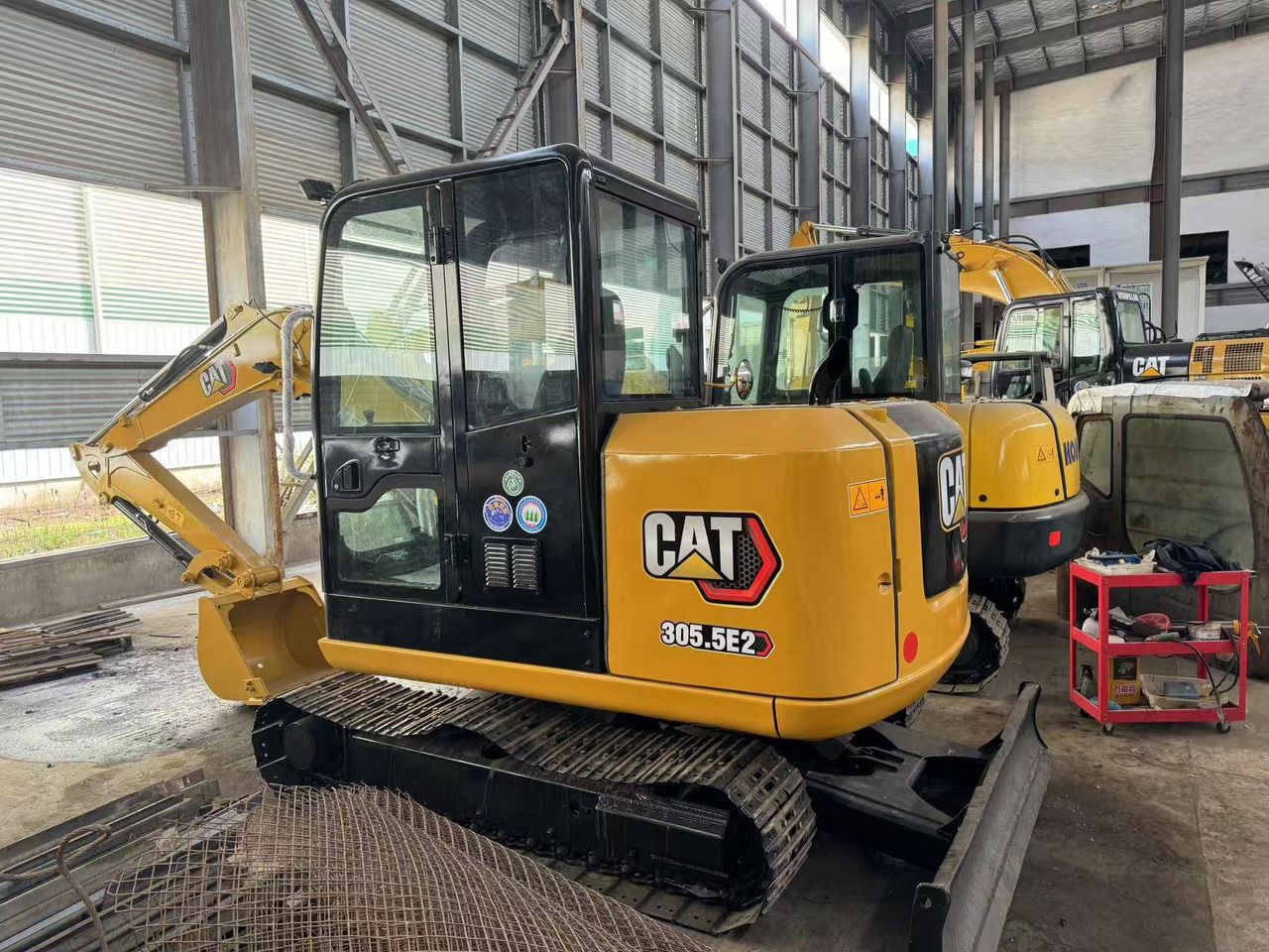 2024 Caterpillar 305.5E2 mini excavator, rear three-quarter view