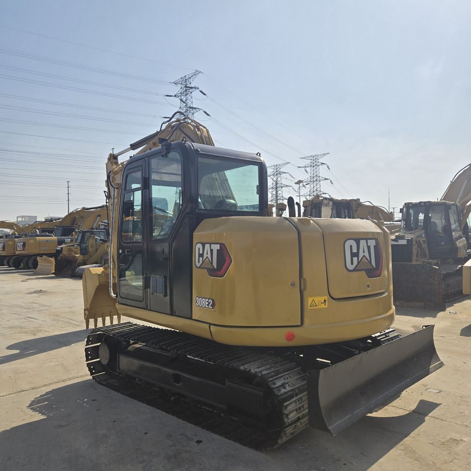 2023 Caterpillar 308E2 mini excavator, rear three-quarter view