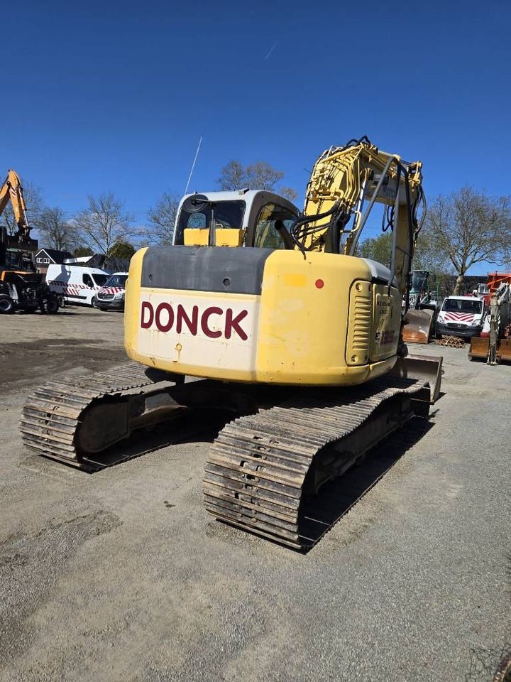 2006 New Holland E135SR-1E crawler excavator, rear three-quarter view 2006 New Holland E135SR-1E crawler excavator, rear three-quarter view