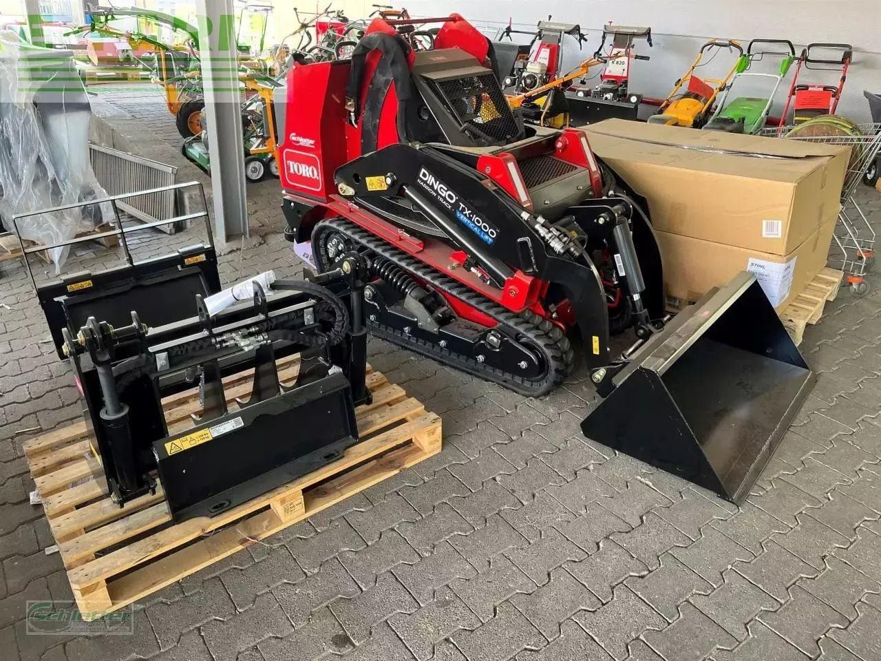 2022 Toro DINGO TX1000 mini excavator with attachments, high-angle view 2022 Toro DINGO TX1000 mini excavator with attachments, high-angle view