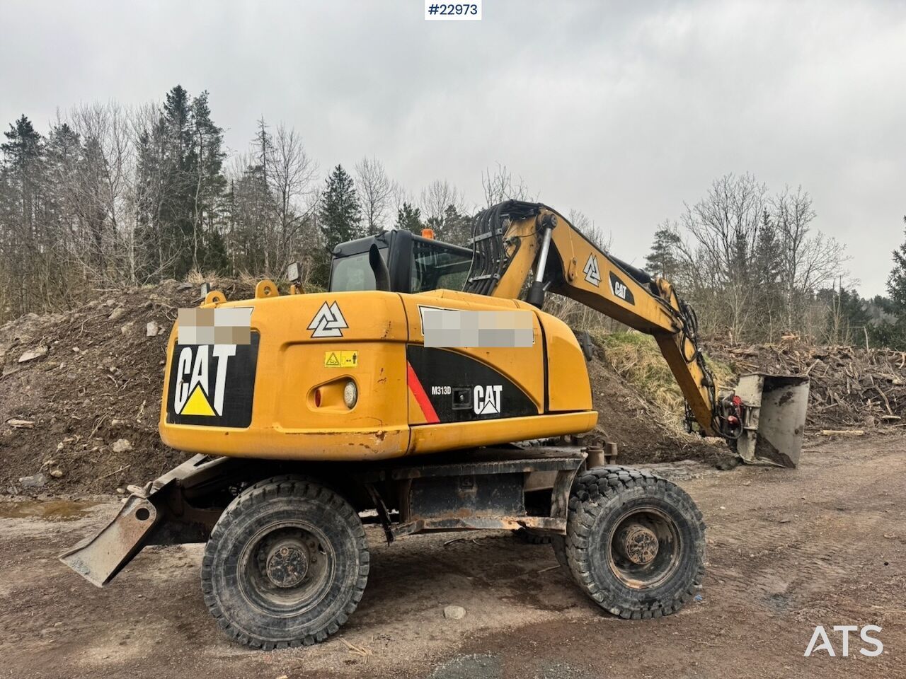2011 Caterpillar M313D wheel excavator, rear three-quarter view 2011 Caterpillar M313D wheel excavator, rear three-quarter view