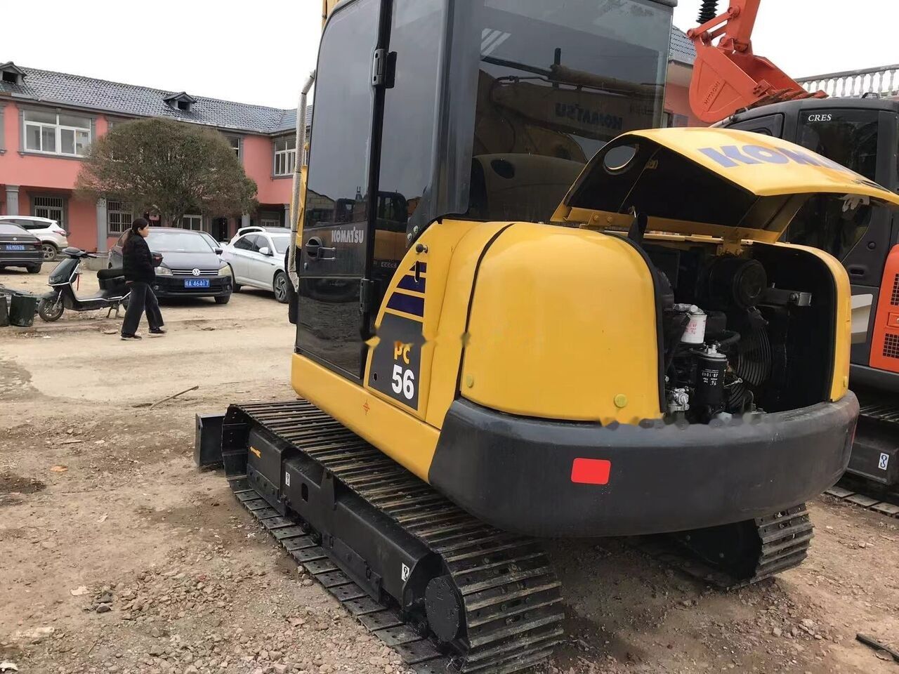 2021 Komatsu PC56 mini excavator, rear three-quarter view with engine cover open 2021 Komatsu PC56 mini excavator, rear three-quarter view with engine cover open