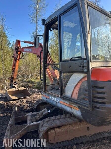 1999 Kubota KX91-2 mini excavator, side view of cab and boom