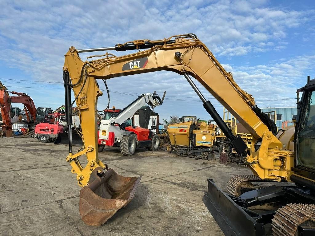 2015 Caterpillar 308E2CR mini excavator side view 2015 Caterpillar 308E2CR mini excavator side view